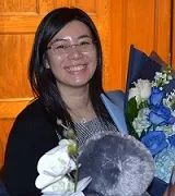 Alumna Ginna Ng with flowers