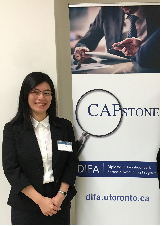 Alumna Ginna Ng next to DIFA Capstone banner