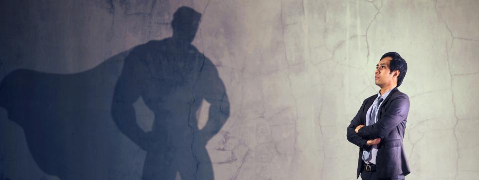 Male Accountant looking at his Superhero shadow